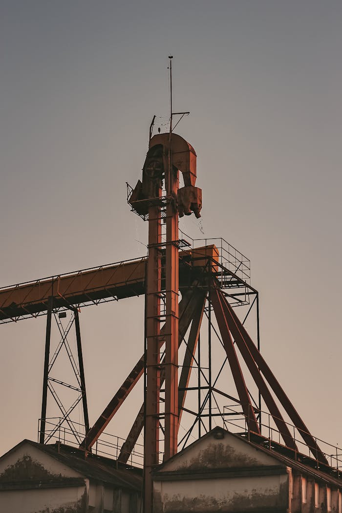 A towering industrial structure silhouetted against a twilight sky, showcasing modern architecture.